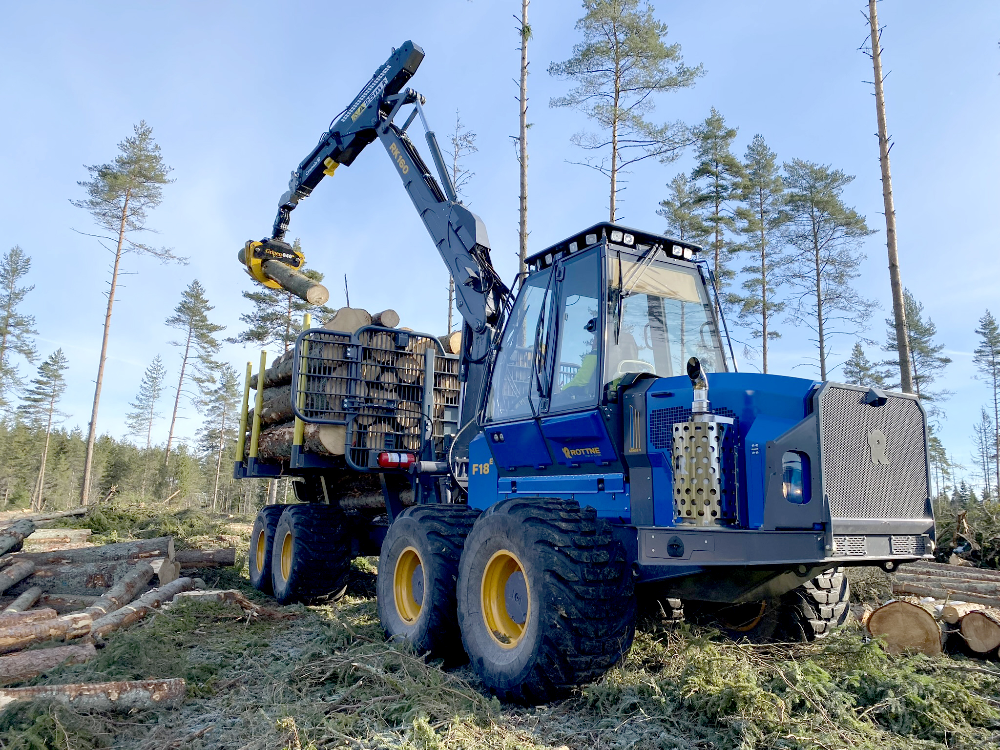 Rottne F18E forwarder forestry machine loading cut timber logs for Jim Wilmer and Sons in Scotland.